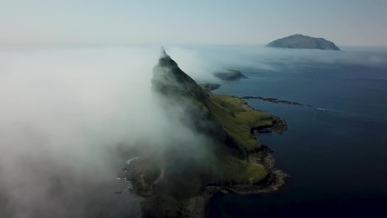Aerial flight next to the famous Tindhólmur island in Faroe Islands
