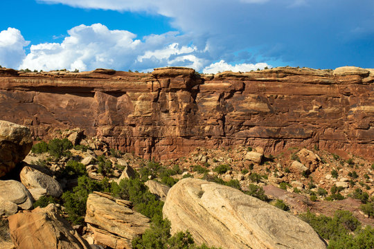 Afternoon light on steep bluffs and fallen rocks near the eastern side of Colorado National Monument, as seen from Rim Rock Drive near Grand Junction