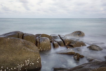 Obraz premium Long Exposure of Sunset at the sea,Larn hin khao , Rayong,Thailand , sunset at White rock beach , Rayong