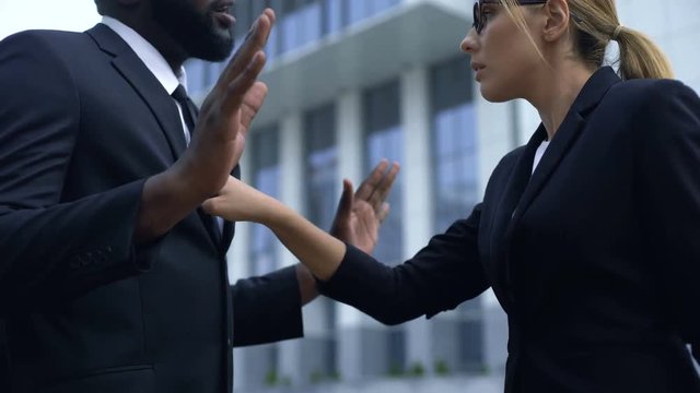 Woman scolding afro-american employee, racial discrimination at workplace
