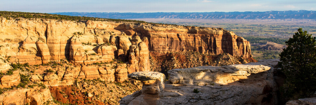 Early-morning light on the massive 300' high Wingate Sandstone walls of Columbus Canyon from "Cold Shivers Point" at Colorado National Monument