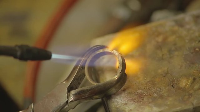 Italian Goldsmith at work building an engagement or a wedding ring.