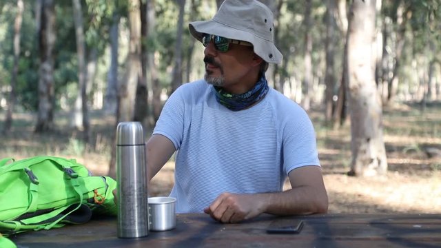 Man suffering from itch after mosquito bites in forest