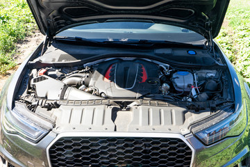 The engine of the modern car, the bonnet is open.
