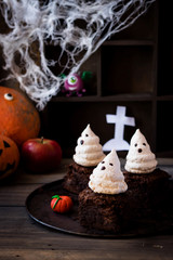 Brownie with ghosts of meringue as the idea of a dessert for Halloween