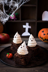 Brownie with ghosts of meringue as the idea of a dessert for Halloween