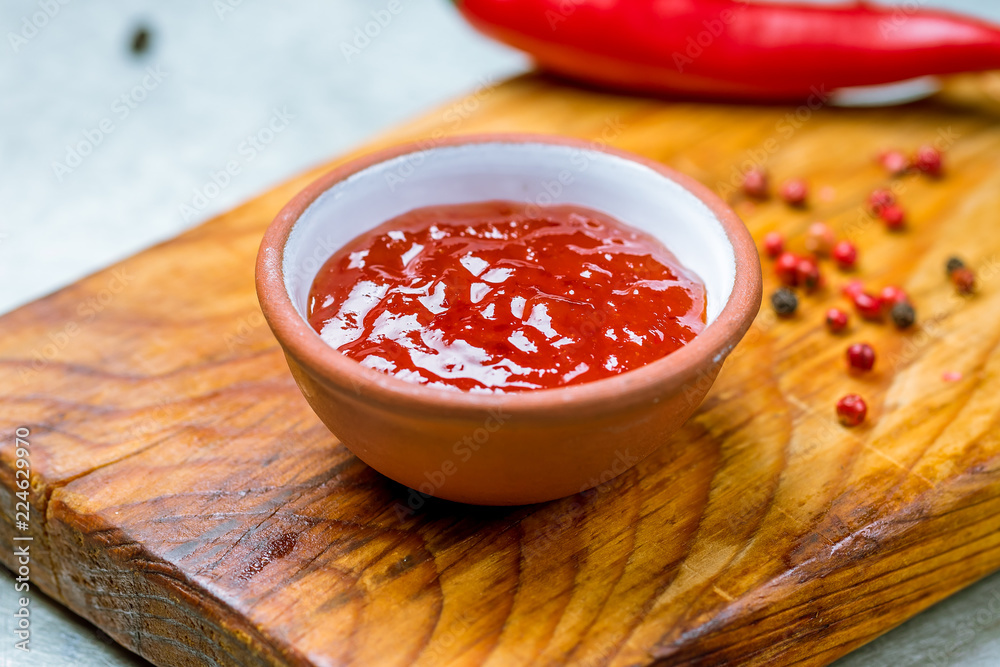 Wall mural chili sauce in gravy boat