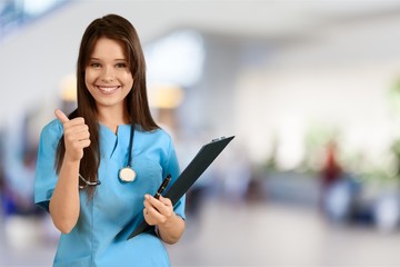 Attractive young female doctor showing thumb up