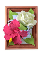 Isolated handmade flowers of polymer clay in a frame