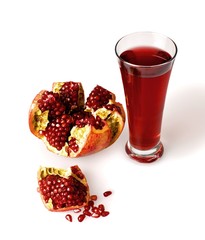Glass of freshly squeezed pomegranate juice with a pomegranate