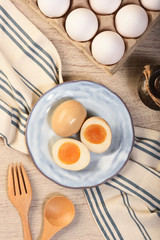 Plate of soft boiled eggs on wooden table