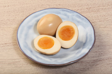 Plate of soft boiled eggs on wooden table