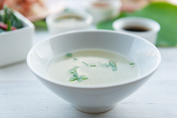 Clear soup in a white cup