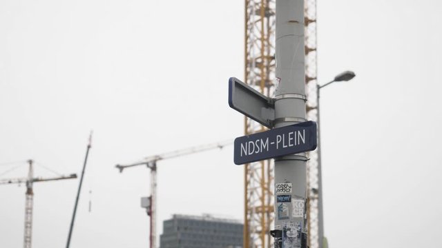 A few cranes and a sign of the NDSM plein. This is a big booming building site in Amsterdam.