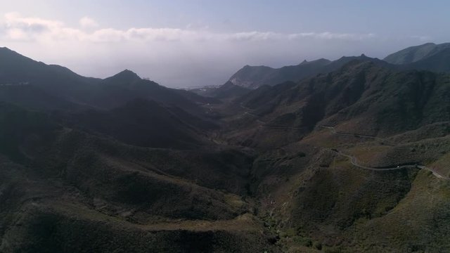 Aerial - Person paragliding over distant city