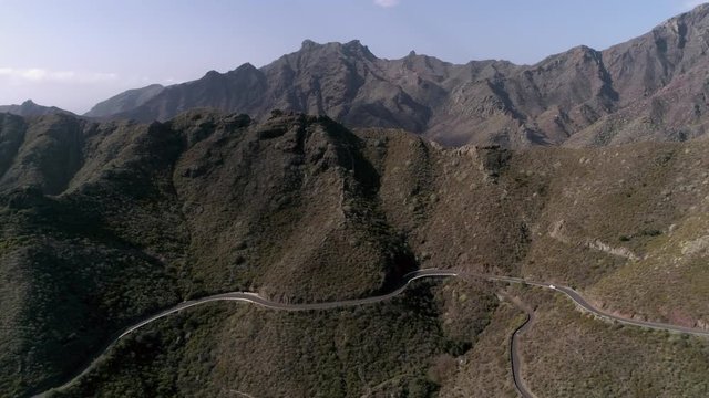 Aerial - Person paragliding over distant city