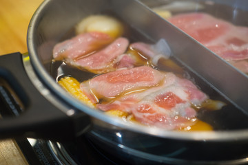Closeup of sliced pork in hot pot