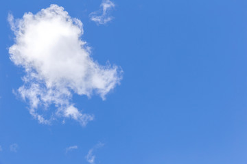 Blue sky background with white clouds, rain clouds.
