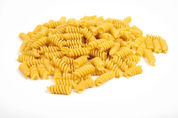 uncooked fusilli pasta noodles isolated on white background