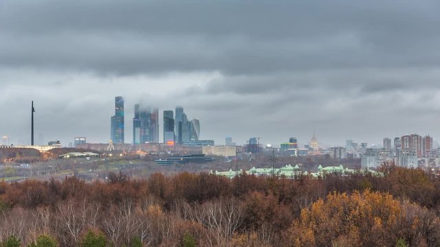 Timelapse of aerial wiev on Moscow city at cloudy autumn evening: day to night transition