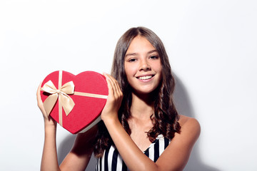 Cute girl holding gift box on white background