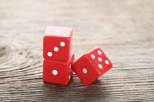 Red dice on grey wooden table