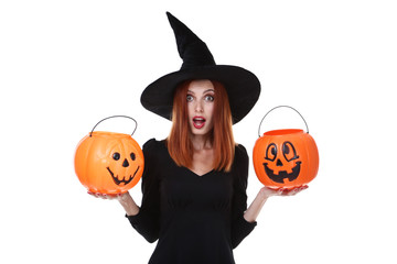 Beautiful redhaired woman in halloween costume with pumpkin buckets on white background