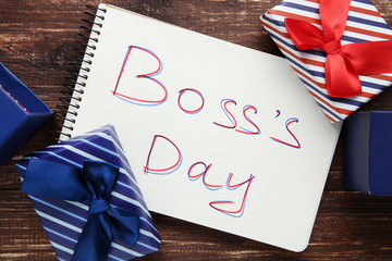 Inscription Boss Day in notebook with gift boxes