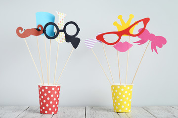 Paper booth props for party in cups on grey background