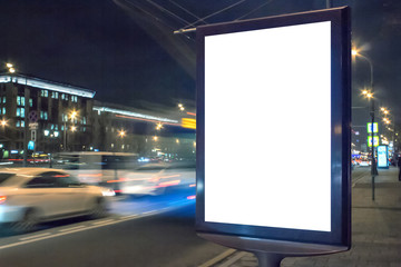 Blank white lightbox at night. Mock-up design concept. Car lights in motion blur