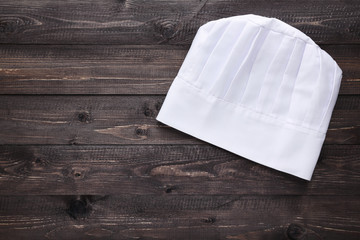 Chef hat on wooden table