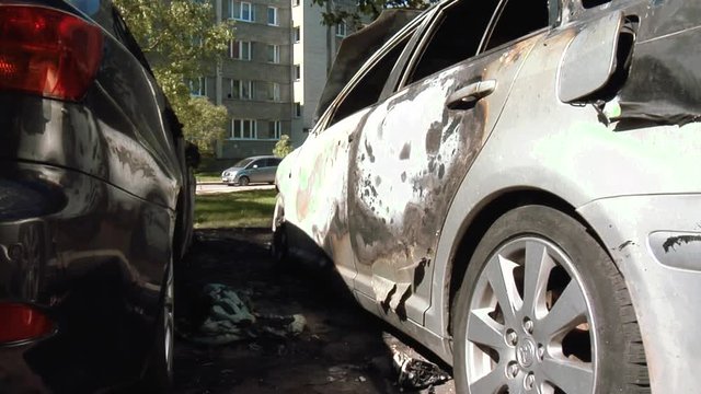 The Car After the Fire. Burnt Out Car With an Open Hood. Engine Burned Out Car Wreck After a Fire. Vandalism.