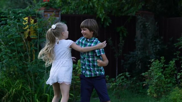 Friendly cousins playing together, hugging to support each other, childhood
