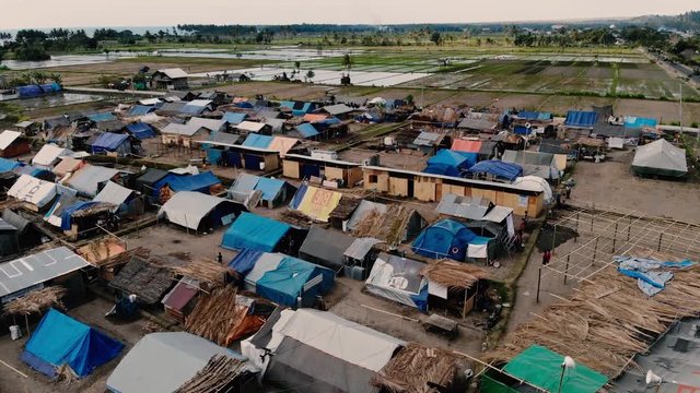 A cinematic aerial shot of a relief camp in north Lombok where hundreds of earthquake survivors are now living