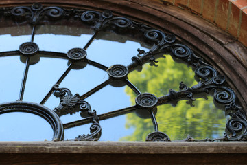 Church window with reflection of tree, sunny summer day.