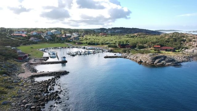 Aerial drone shot of a small marina at the ocean coastline on the west coast of Sweden in Halland outside of Gothenburg.