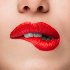 Close-up Beauty Portrait Model Big Sexy Lips, Mouth Open, White Teeth Bit her lower Lip, Seductive Lips Red. Macro image of Perfect Plump Lips. Beautiful Woman Bit her Lip Passionately, white Teeth