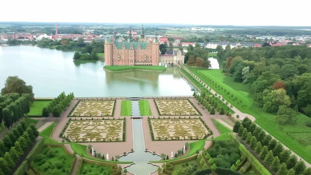 Aerial shot over an opulent garden and castle in Hillerod Denmark