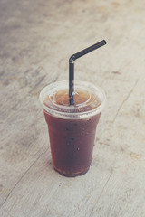 Iced americano black coffee on old a wooden desk