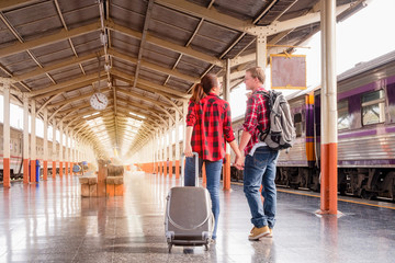 Young traveling backpacker on vacation at the train station, travel concept