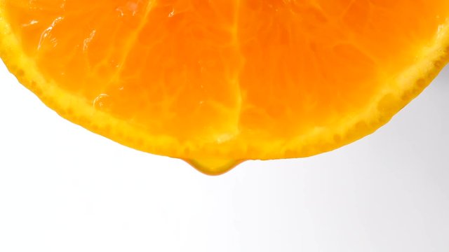 Drops of juice of a citrus on white background
