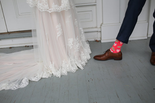 Wedding Photography Bride and Grooms Feet – Blue Wedding Shoes and Brown Men’s Leather Shoes with Silly Neon Pink Chicken and Waffles Socks