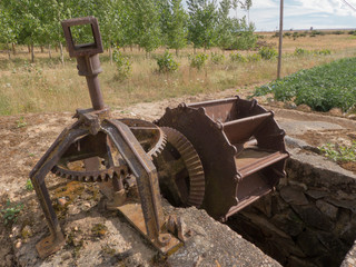 VINTAGE WATERWHEEL IN THE FIELD