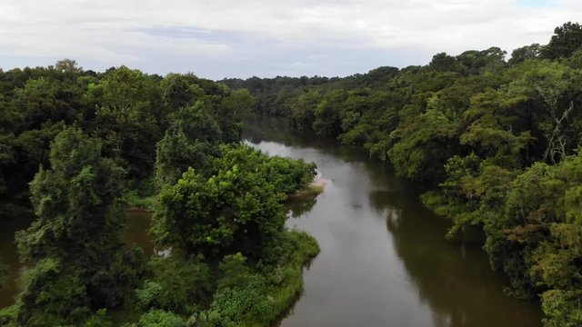 Tree top drone footage flying down the San Jacinto River near Houston, Texas