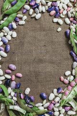 Multicolored beans lie on burlap