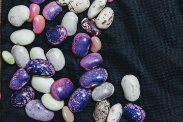 Multicolored beans lie on black background