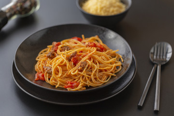 Delicious spaghetti with Bolognese sauce served on a black plate