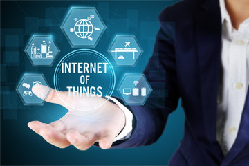 Businessman holding icon of IOT.Internet of things technology concept..