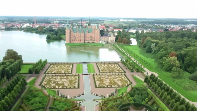 Aerial shot over an opulent garden and castle in Hillerod Denmark
