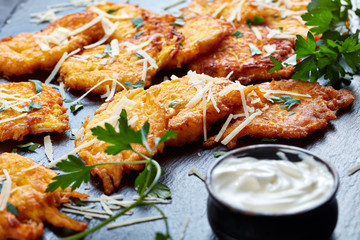 fried pumpkin fritters with sour cream, close up